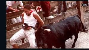 A runner taunting a charging bull